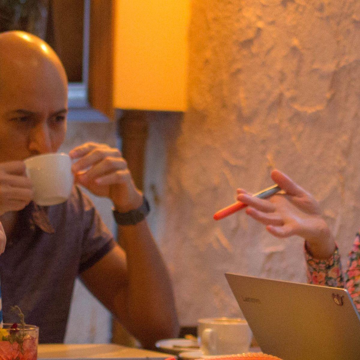 El equipo de Ciempiés (Maui Barone, Erika Cosenza, Javier Rey y Wenceslao Zuloaga) sentado aldedor de una mesa de bar sobre la que se pueden apreciar libros, ordenadores, papeles y bolígrafros. 